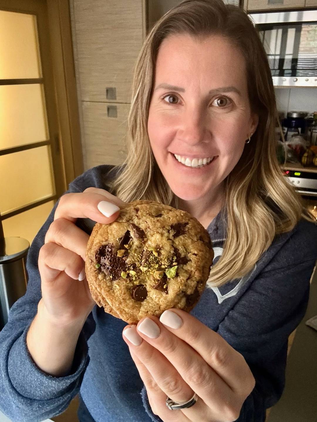 Lauren holding a pistachio cookie. 