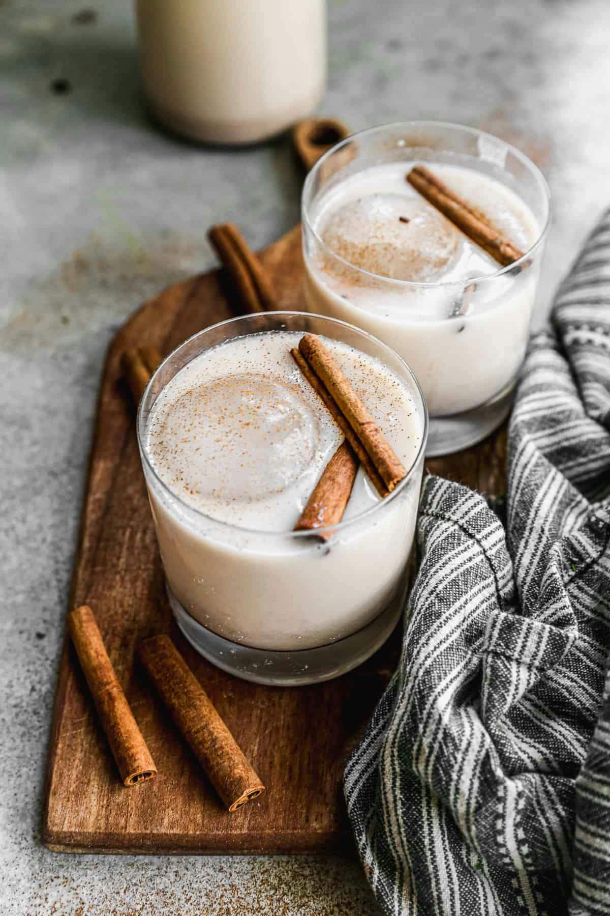 Horchata served with cinnamon sticks in a clear glass