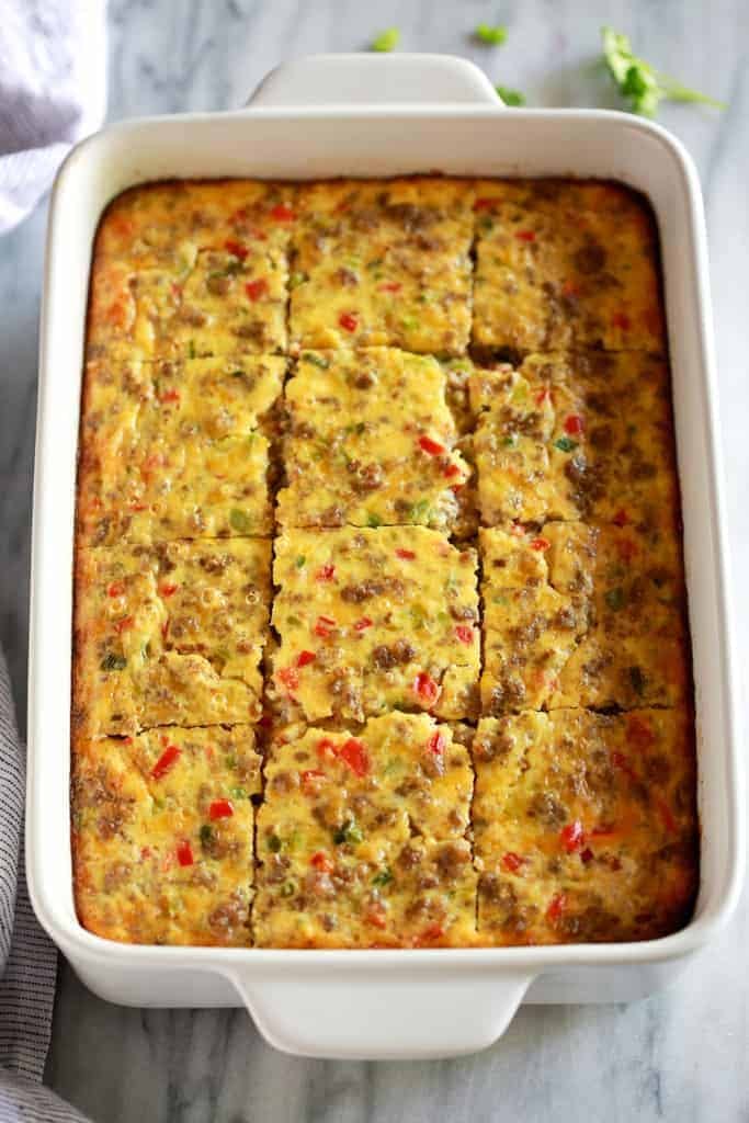 Breakfast Casserole cut into squares and served in a white 9x13 casserole dish