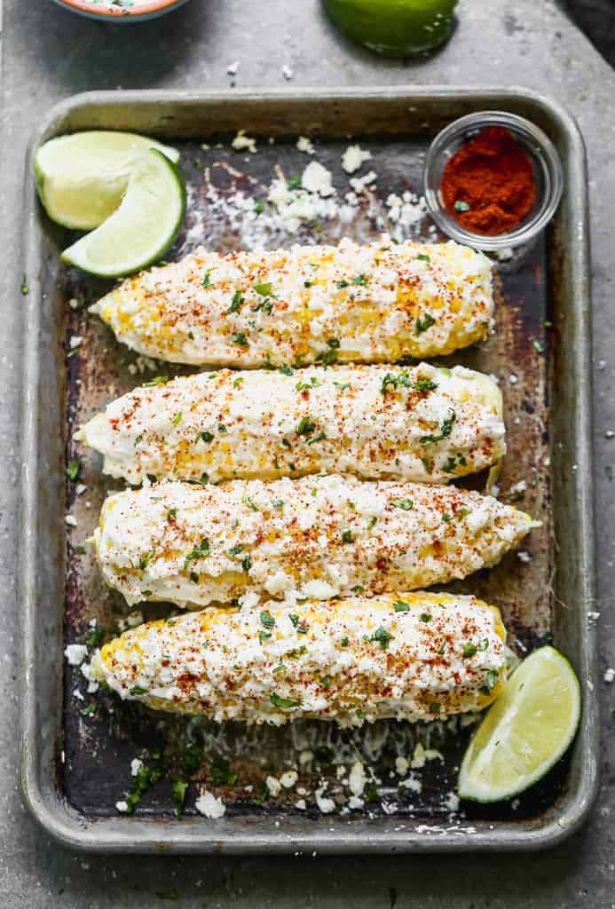 Elote (Mexican Corn) served with lime and spicy mayo