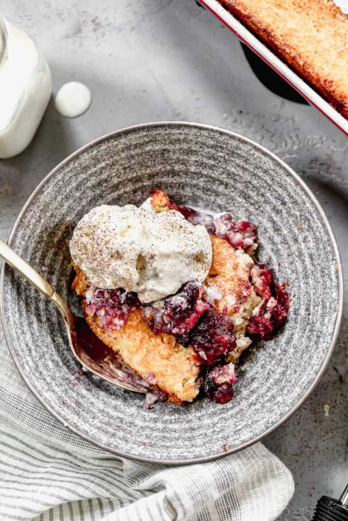 Cherry Cobbler topped with vanilla ice cream and served in a grey bowl