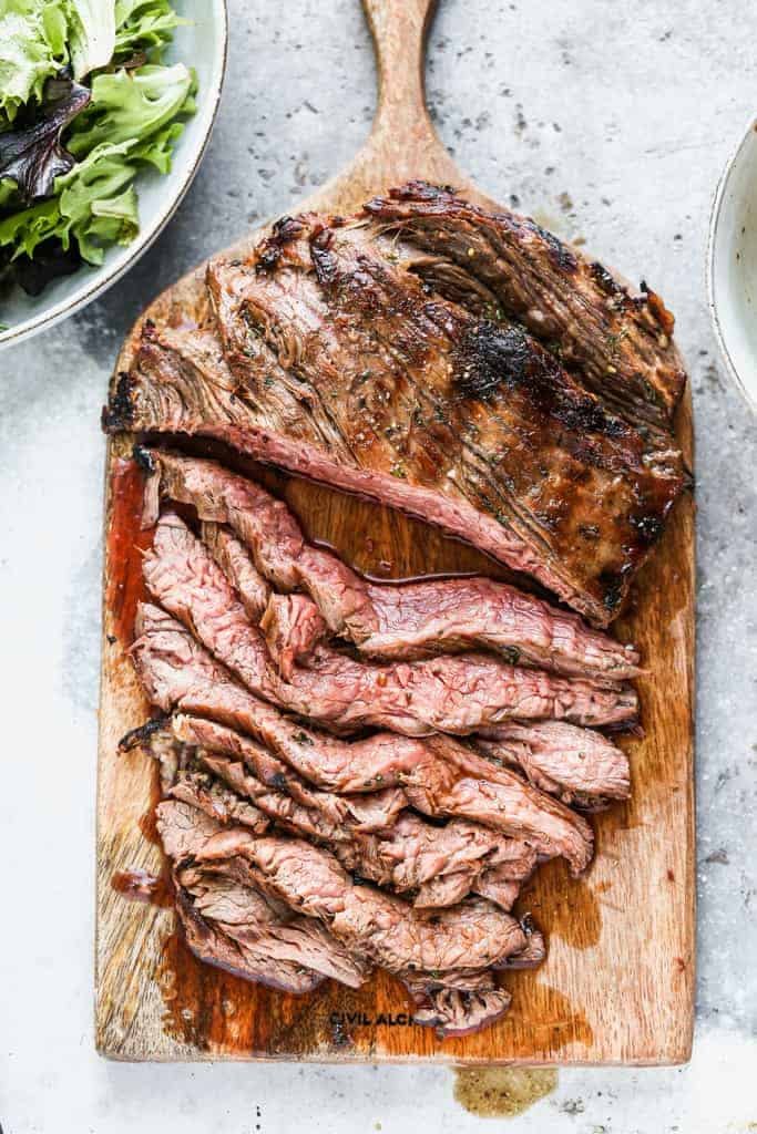 marinated flank steak on a wood board