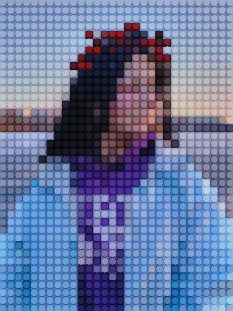 a woman in a blue shirt and purple tie blurred by mosaic