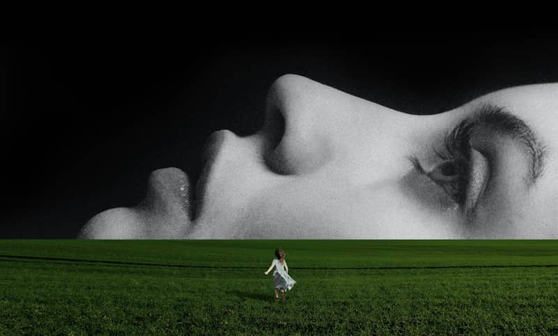A child in a light dress running through a green field toward a giant face