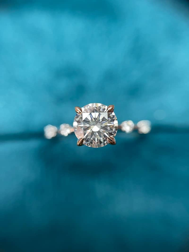 a close up of a diamond ring on a blue velvet