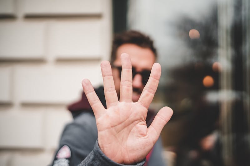 man raising right hand