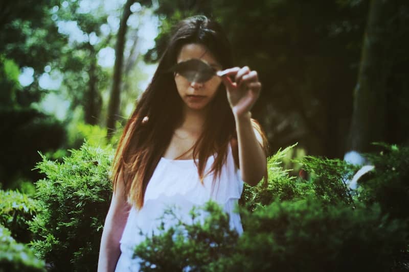 woman holding green leaf