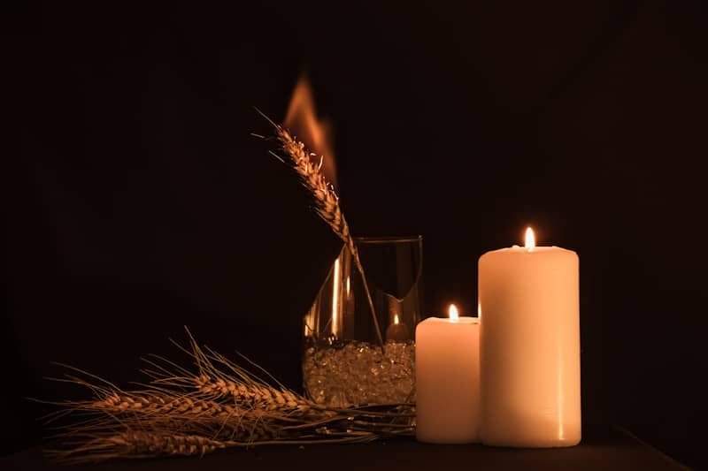 a candle and a glass of water on a table