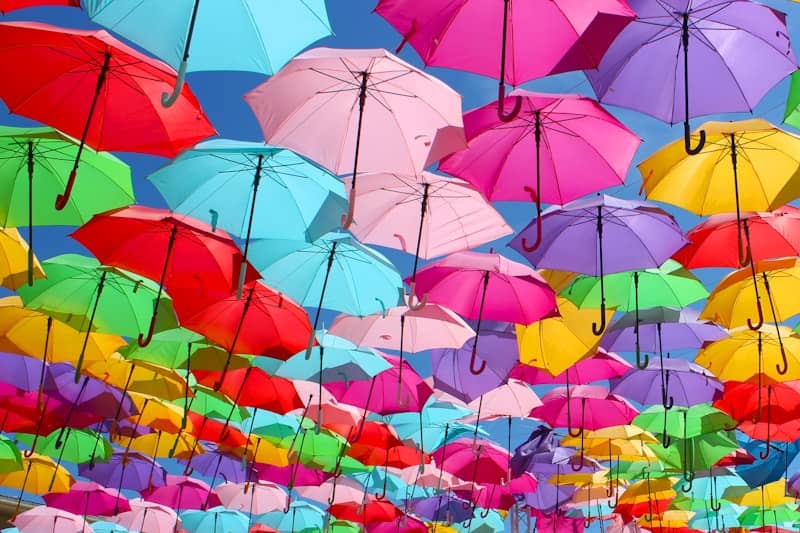 A large group of colorful umbrellas floating in the air