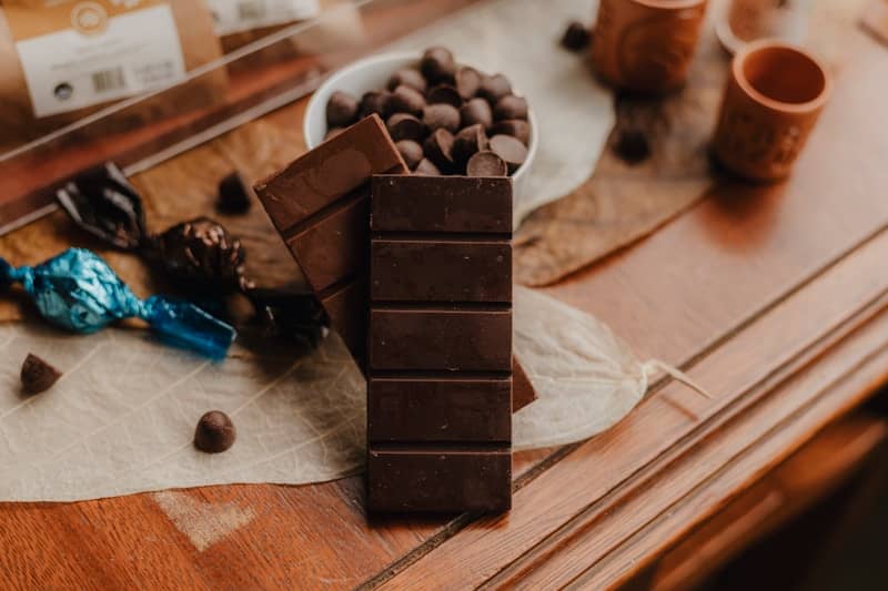A table topped with a bowl of chocolate