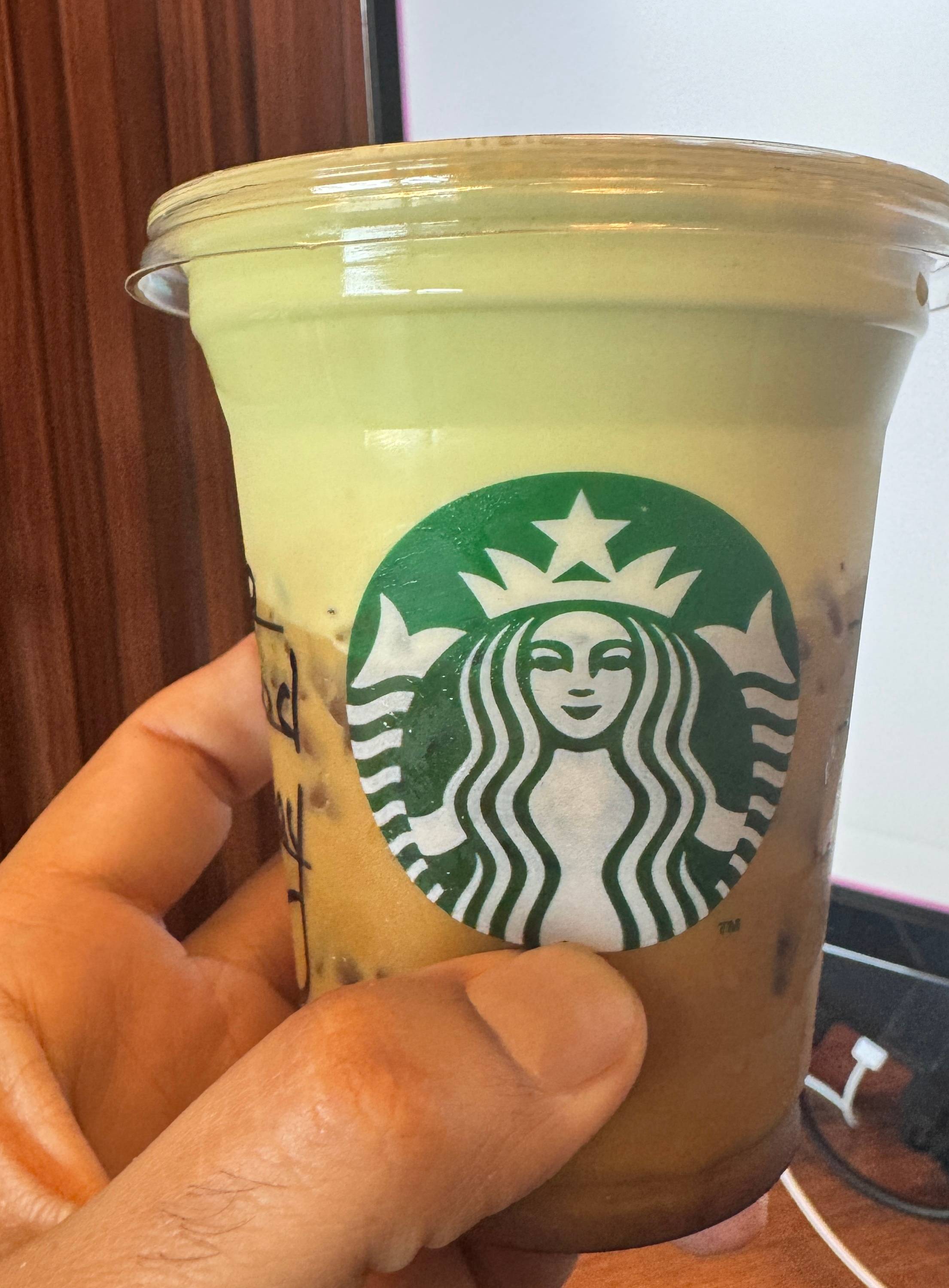 Photo of me holding the starbucks Iced Americano with Pistachio cream