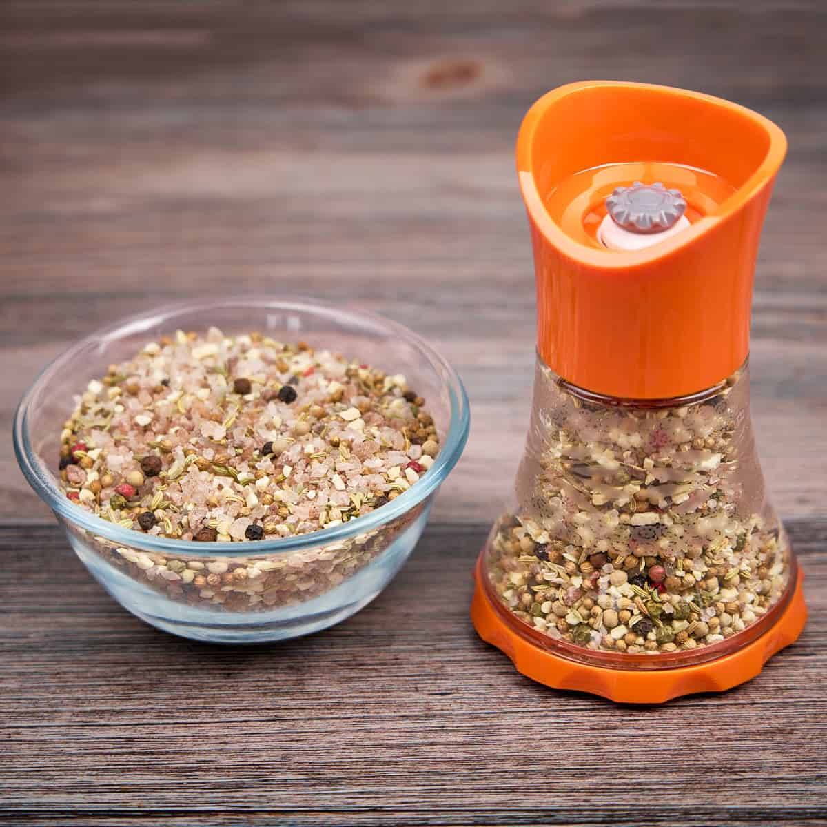 A grinder full of coriander, fennel, and garlic seasoning