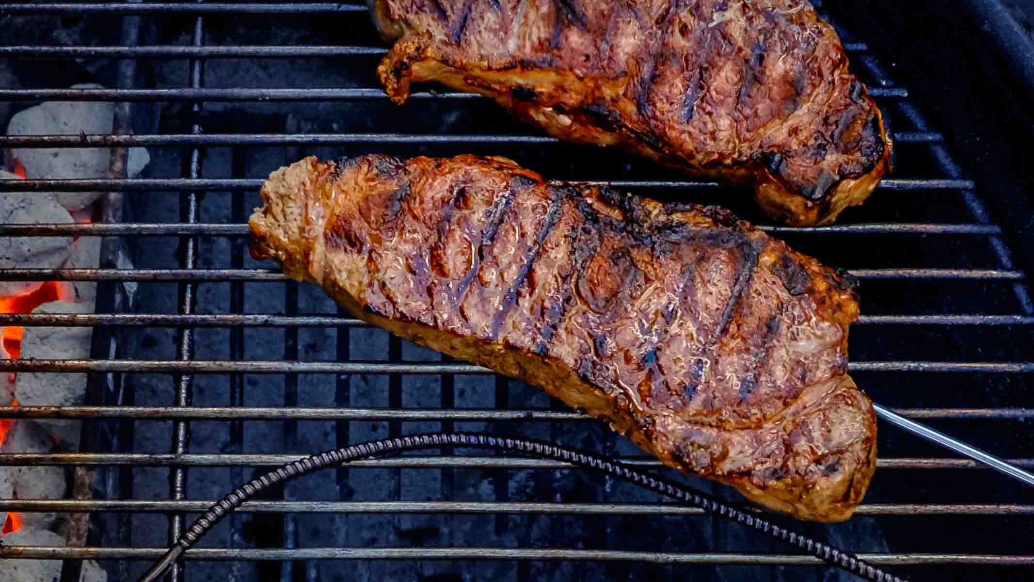 New York strip steaks on the grill