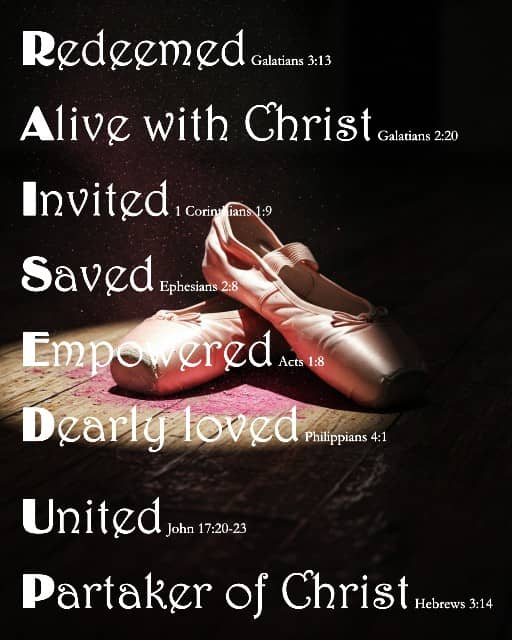 RAISED UP word art on dark background with spotlighted ballet slippers