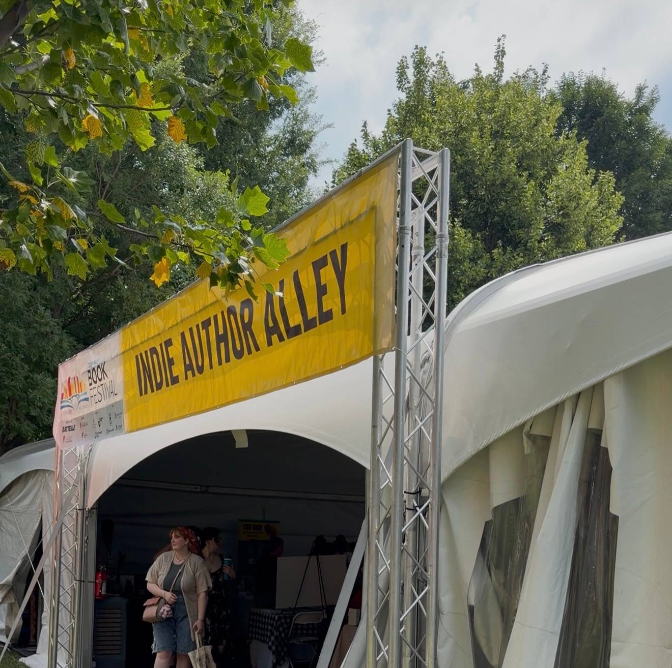 A sign outside a tent indicates Indie Author Alley at Columbus Book Festival