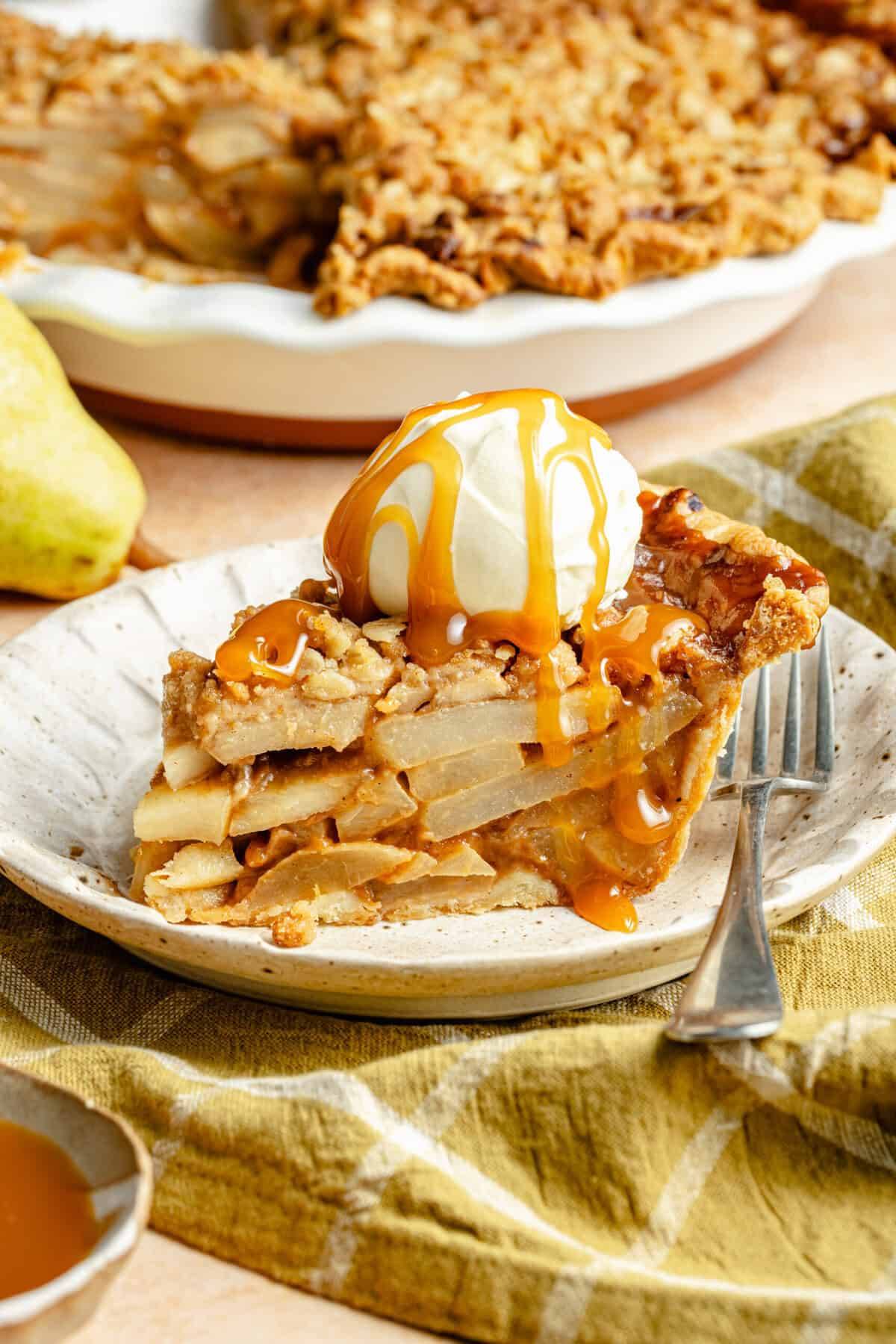 pear pie on plate with ice cream and caramel sauce