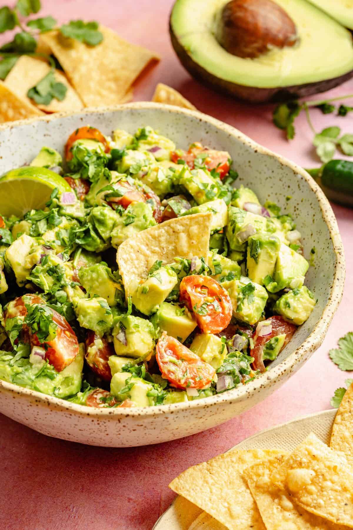 avocado salsa in bowl with chips