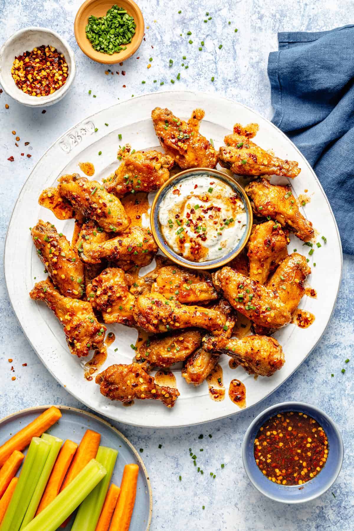 hot honey chicken wings on plate with dip