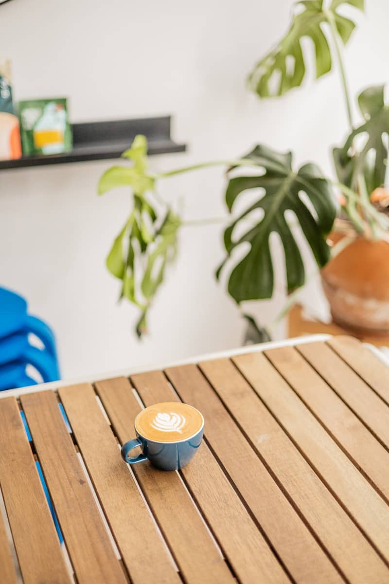 A cup of coffee sitting on top of a wooden table