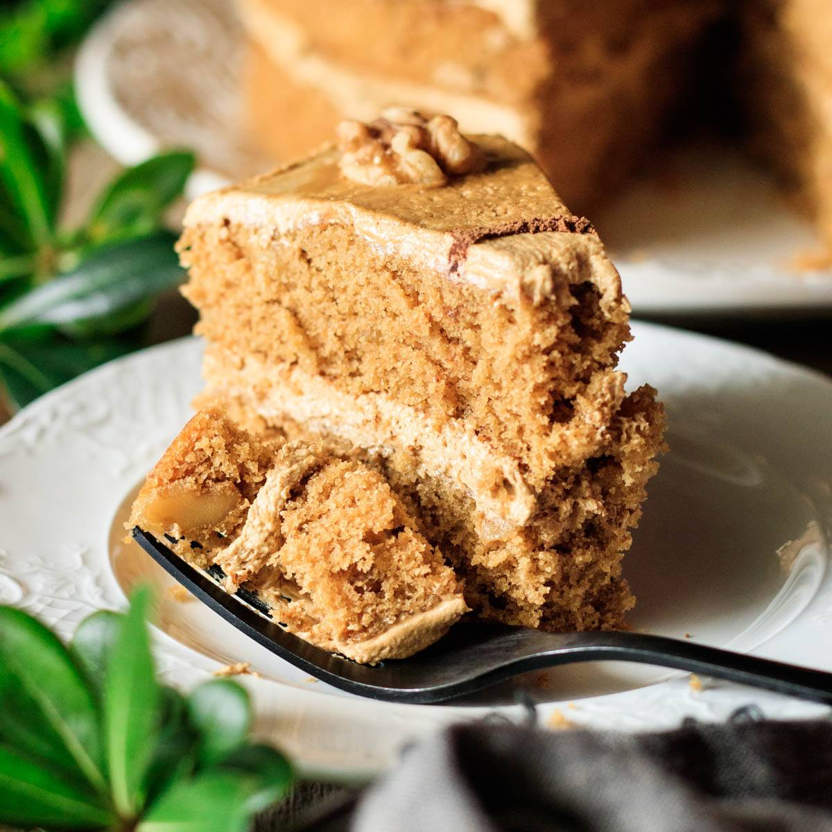slice of coffee and walnut cake on a plate.
