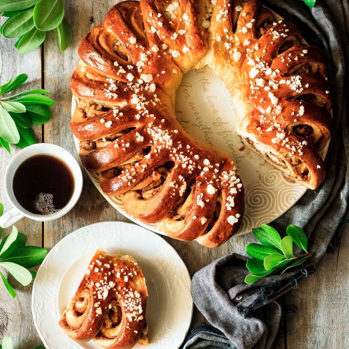 circle of cinnamon roll bread with a cup of coffee.