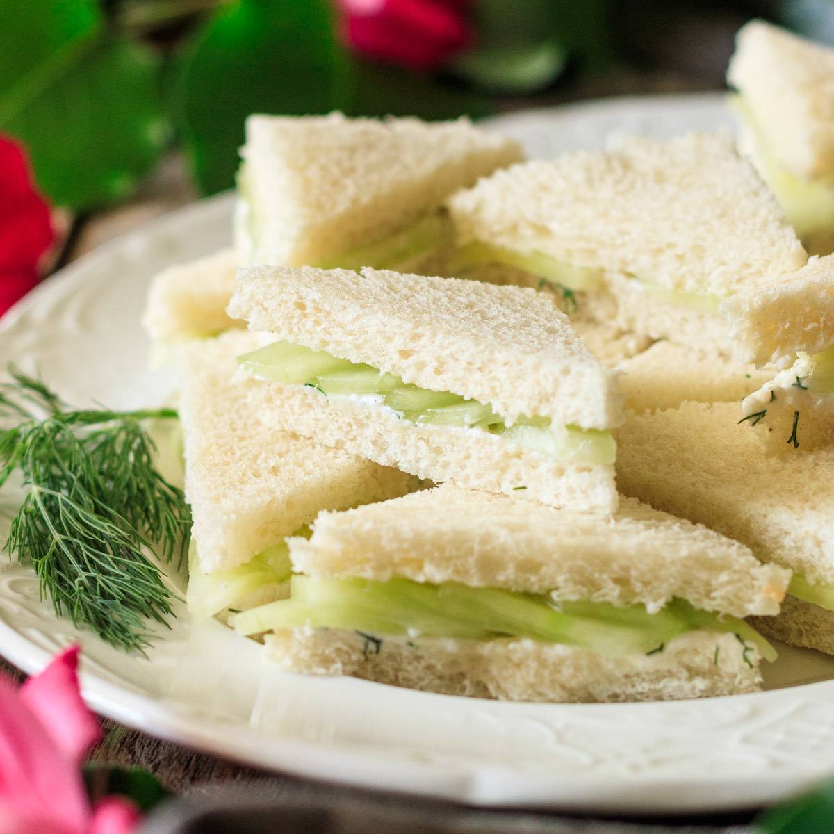 plate of cucumber sandwiches with dill.