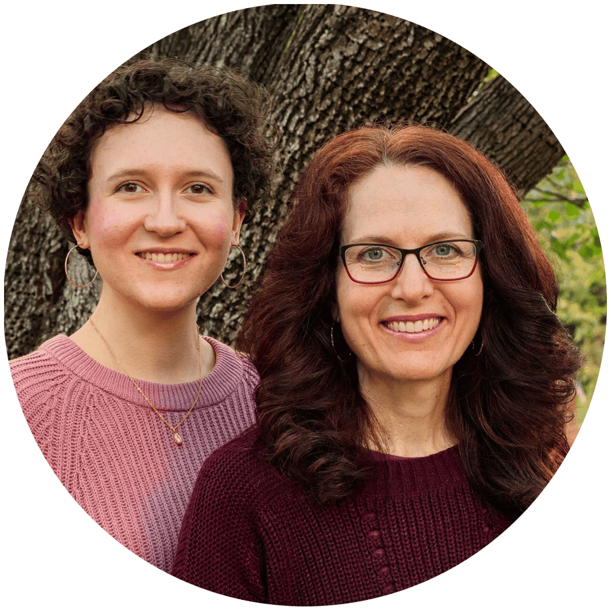two ladies smiling outdoors.
