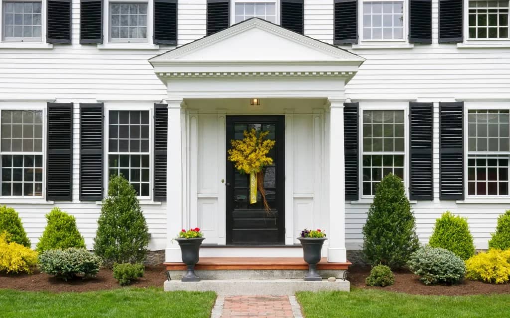 Traditional two-story white home with black shingles