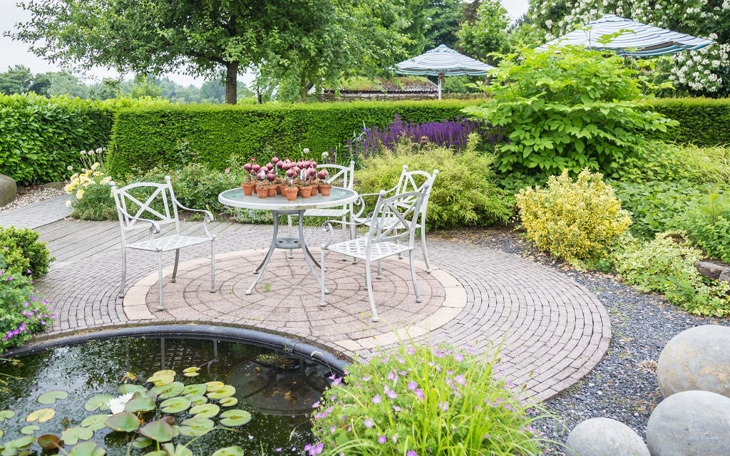 Backyard patio and garden with permeable stones and gravel