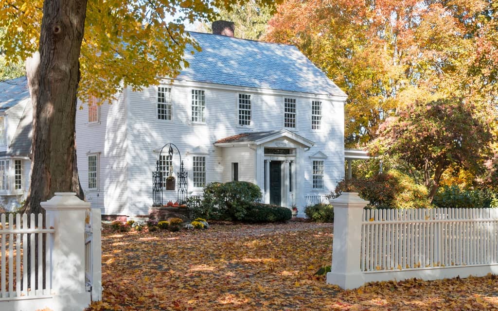 Large traditional home on large lot during autumn