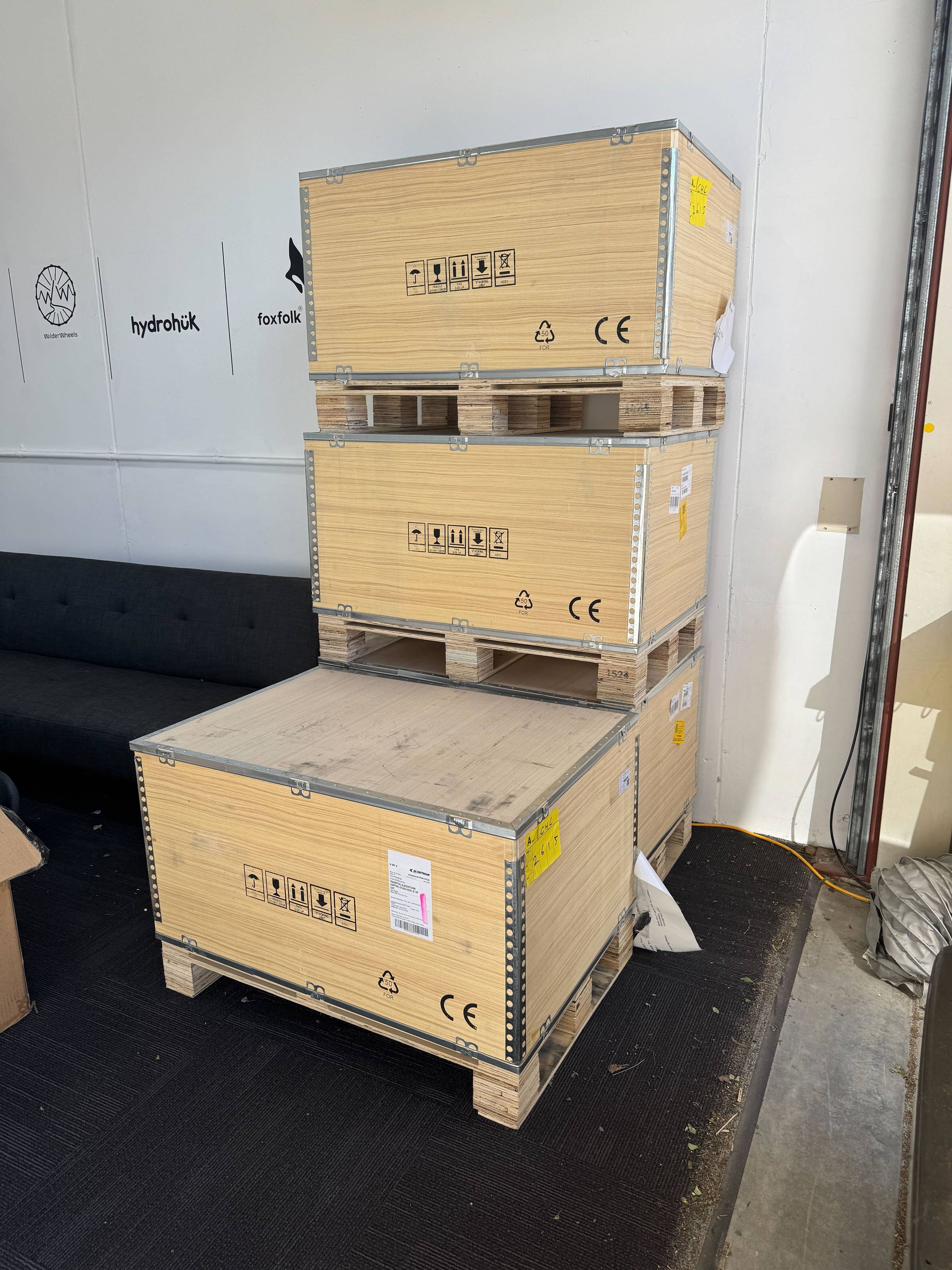 Four large wooden crates in a garage