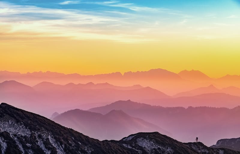 Image of a rainbow sky over the mountains