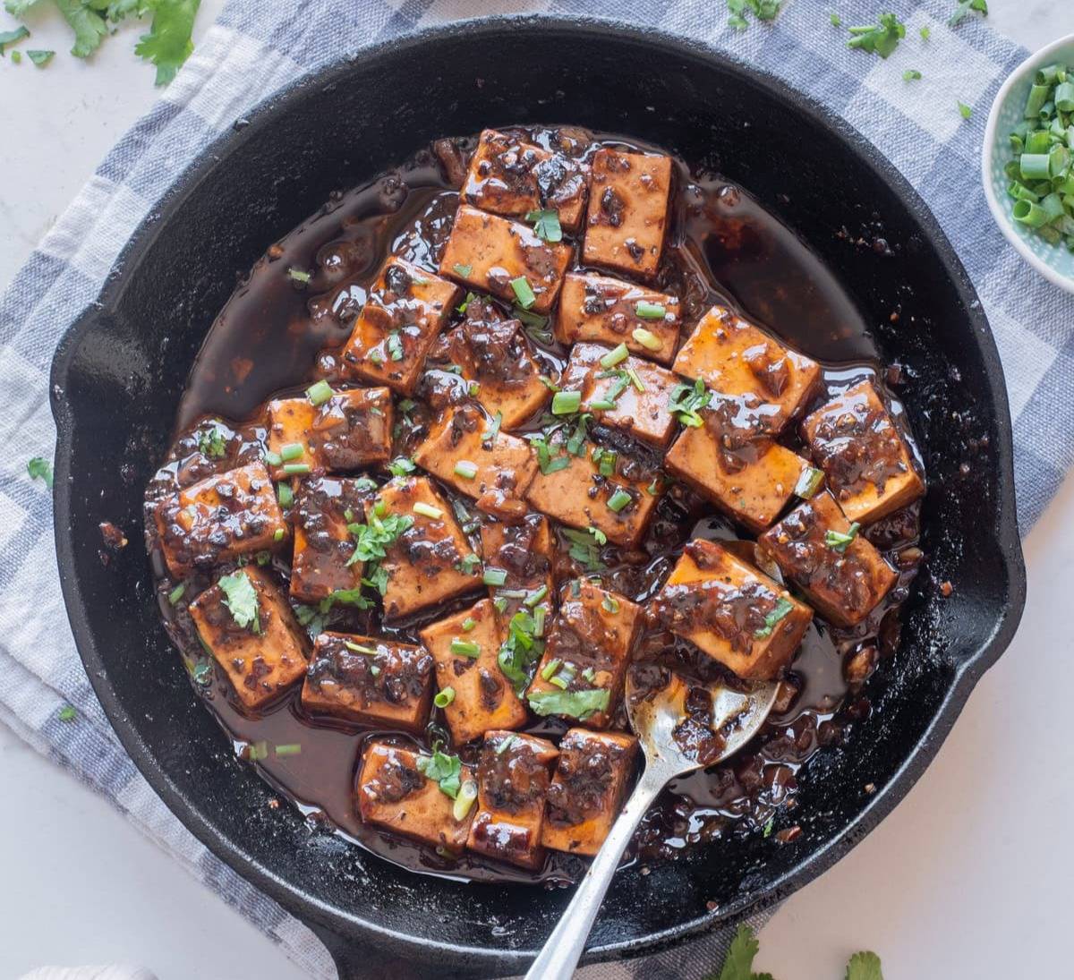 An overhead image of mapo tofu in a skillet, ready for serving.