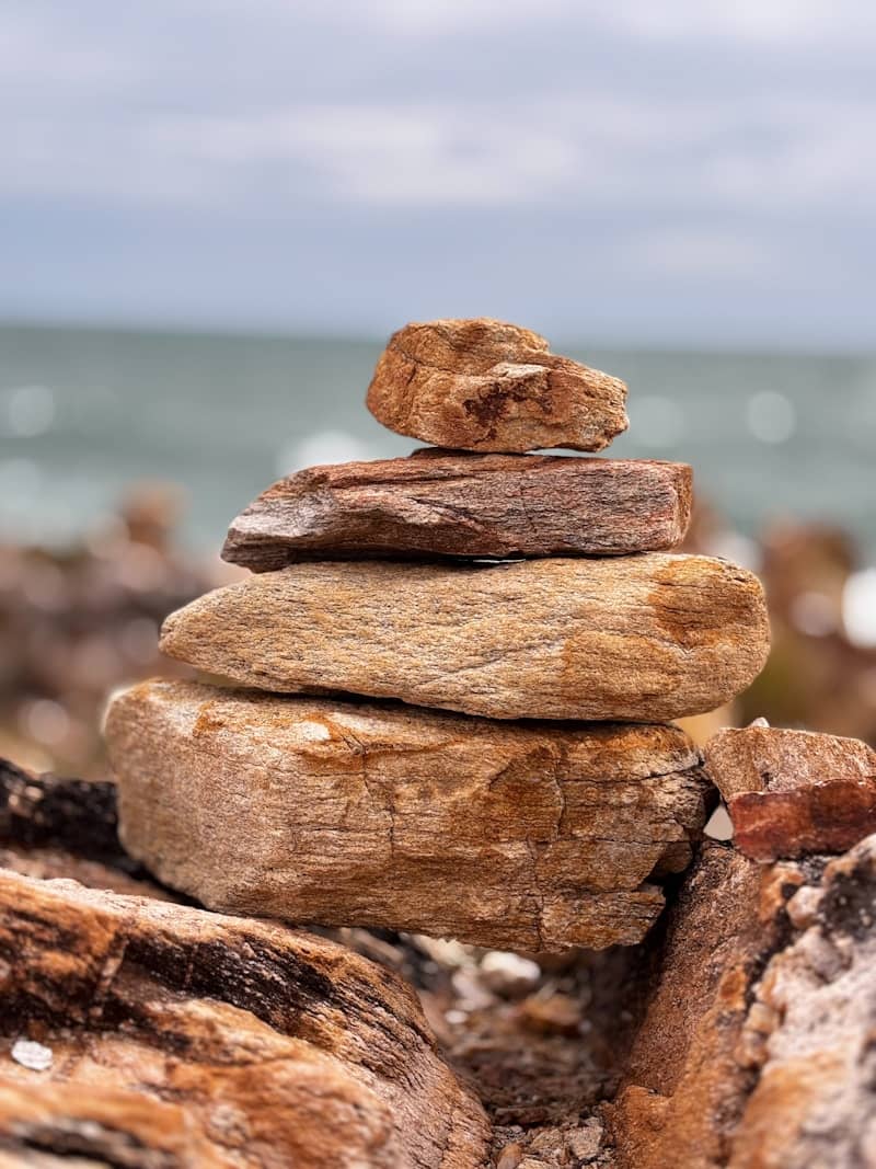Stack of stones on a beach with ocean background