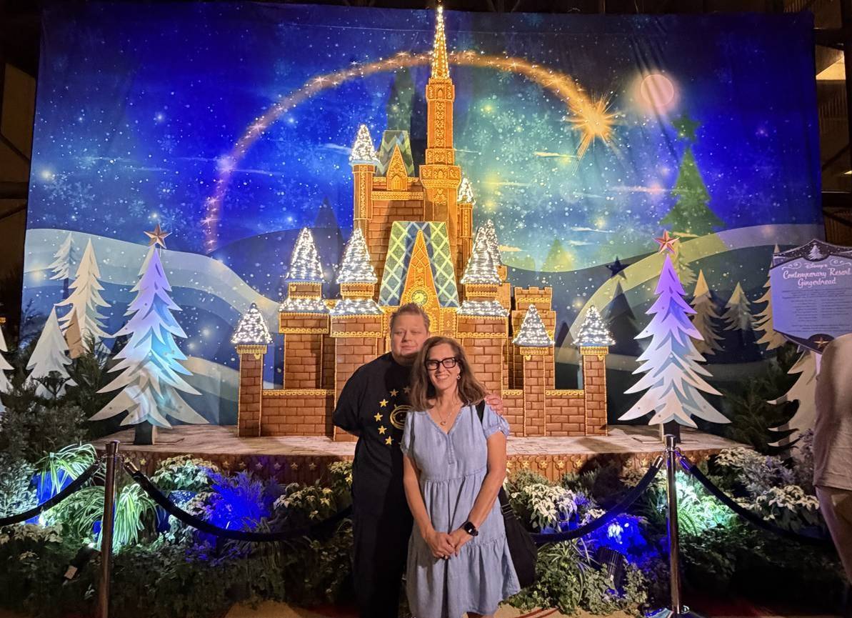 photo of Terry and Leslie at Disney in front of a castle decoration