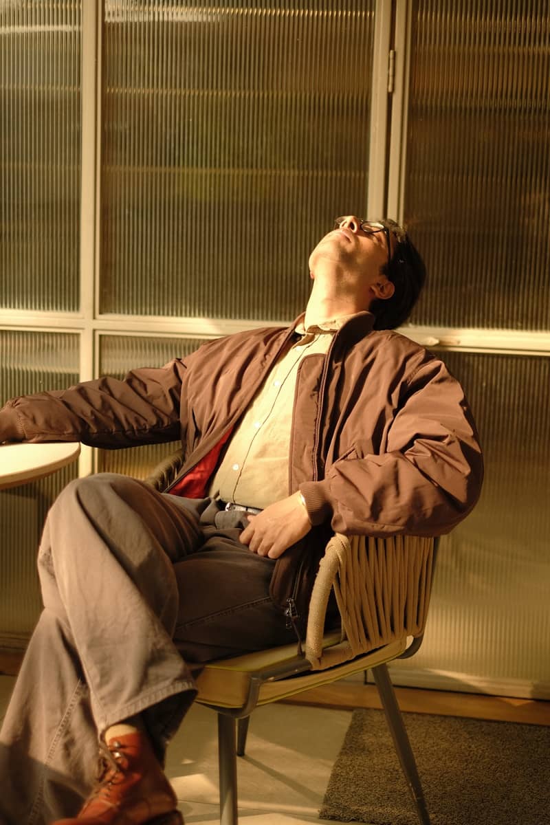 Man relaxing in chair with head tilted back.