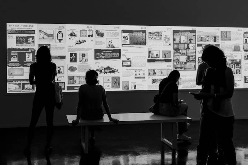 People admire an art display in a gallery.
