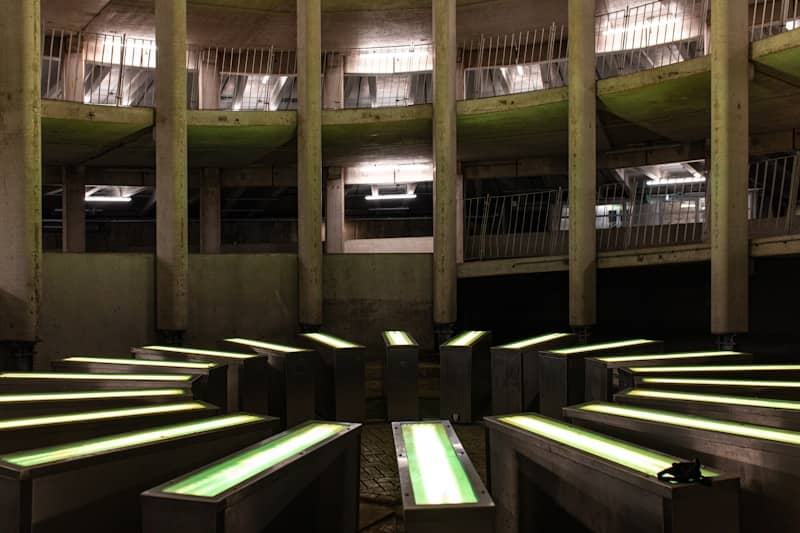 Circular concrete structure with glowing green lights