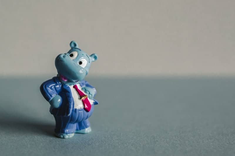 A small toy of a blue bear with a tie