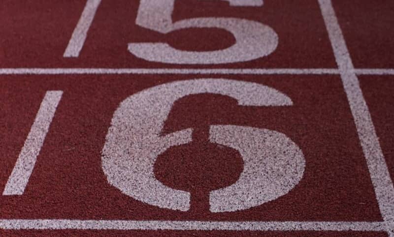 Numbered lanes on a red running track.