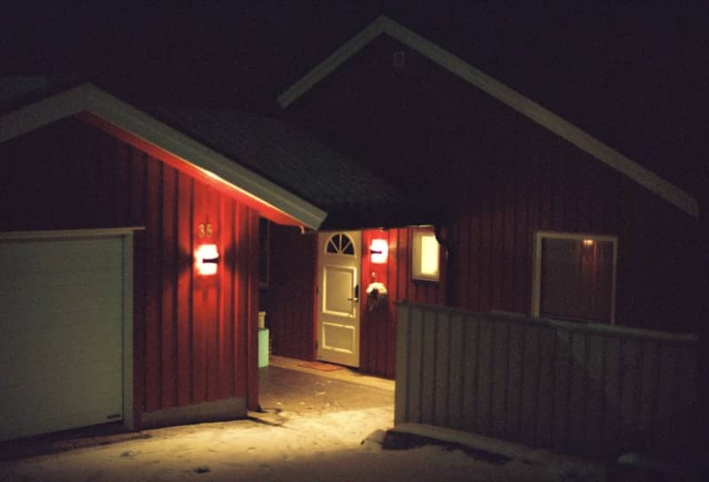 Red house illuminated at night.