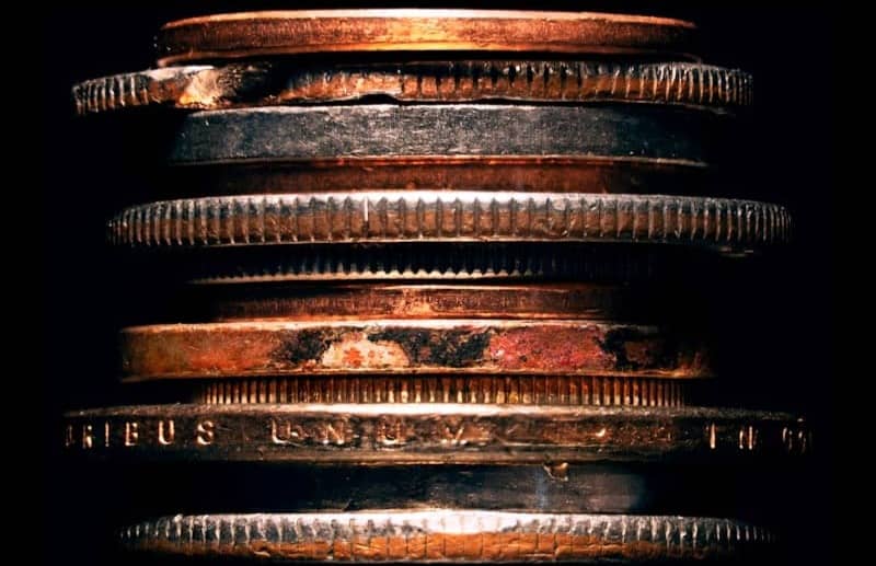 Stack of copper coins against black background
