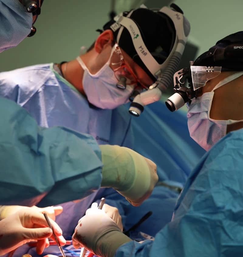 Surgeons performing a complex medical operation together.