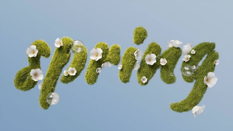 Green moss letters spelling out "spring" with flowers