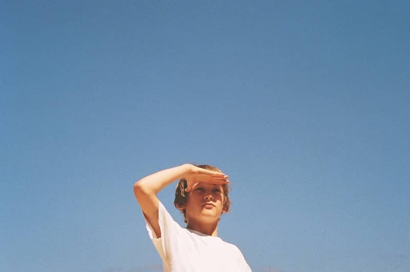 woman in white shirt under blue sky during daytime