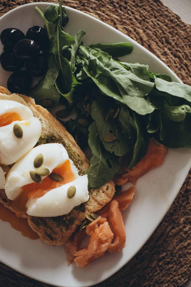 Healthy breakfast with poached eggs, salmon, and arugula