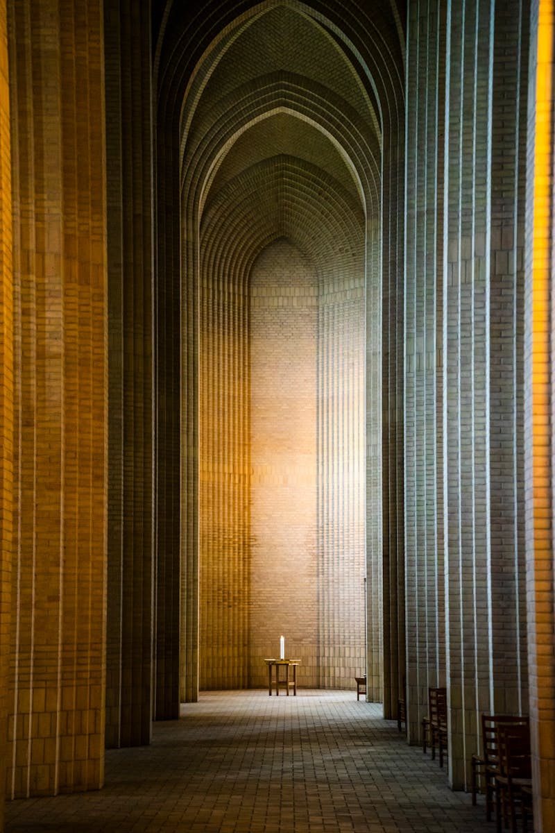 A long hallway with a bench in the middle of it