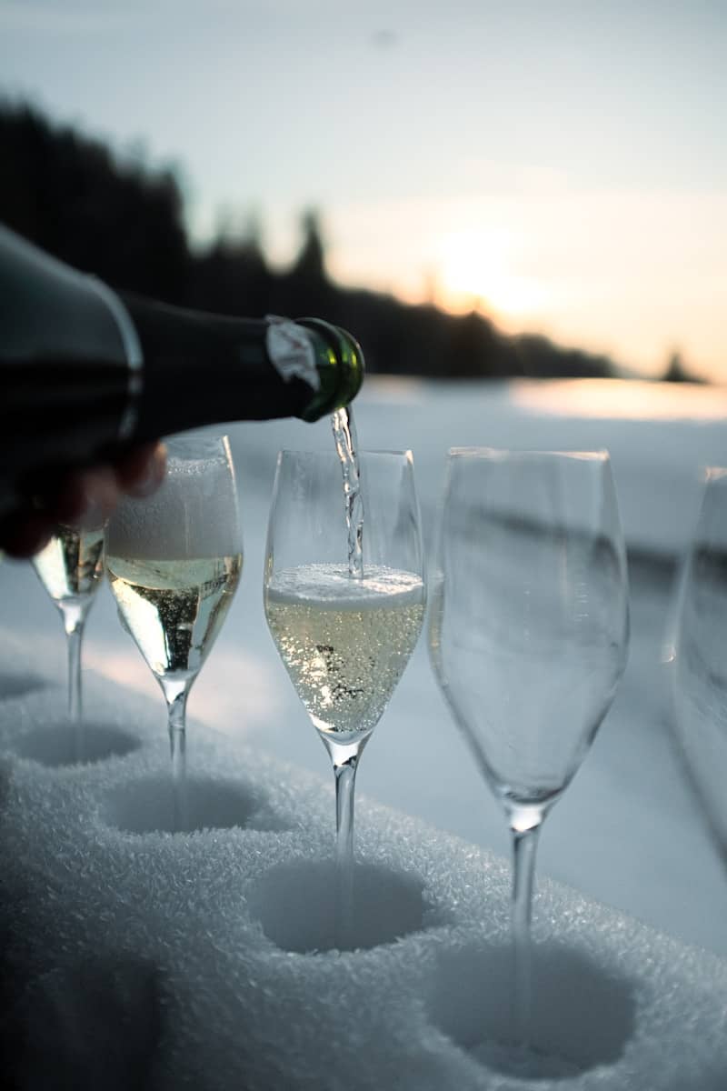 Champagne being poured into glasses in the snow
