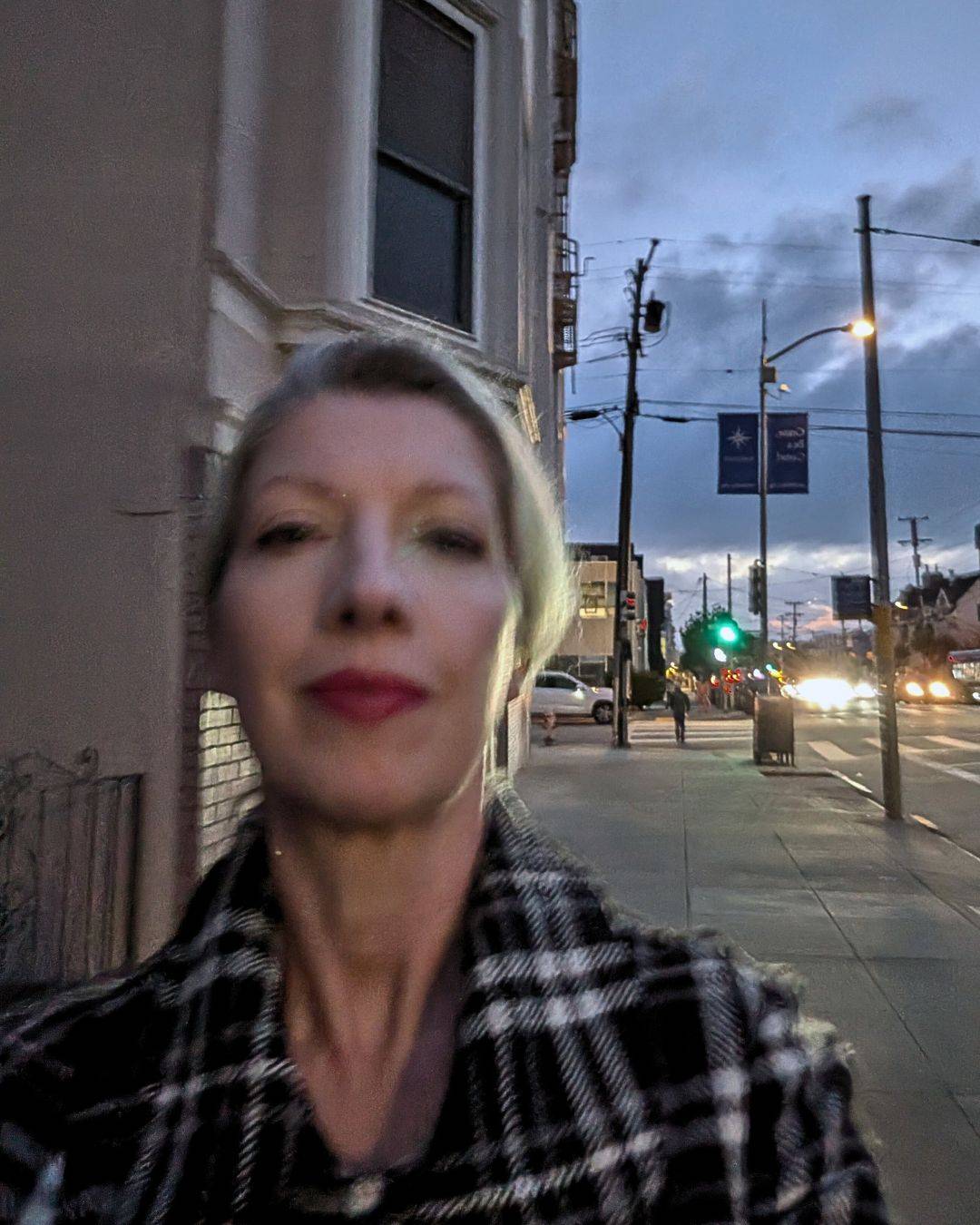 close up of woman's face on city street at night