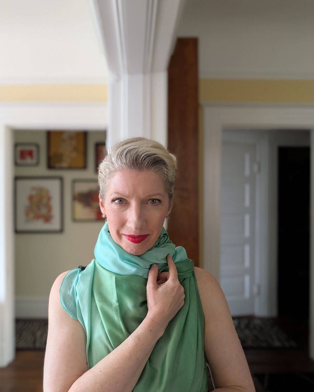 blonde woman with scarf draped around neck